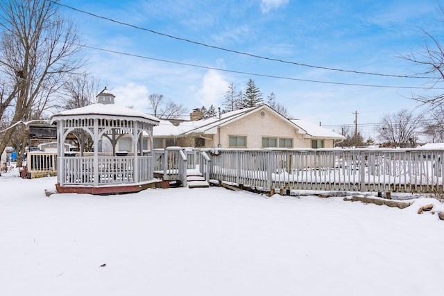 snow covered rear of property featuring a gazebo