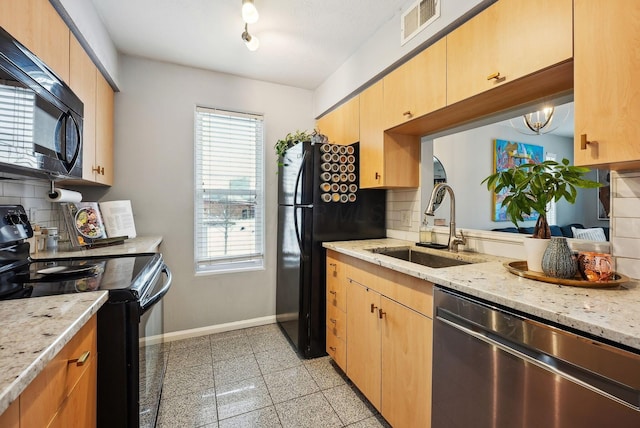 kitchen with black appliances, decorative backsplash, plenty of natural light, and sink