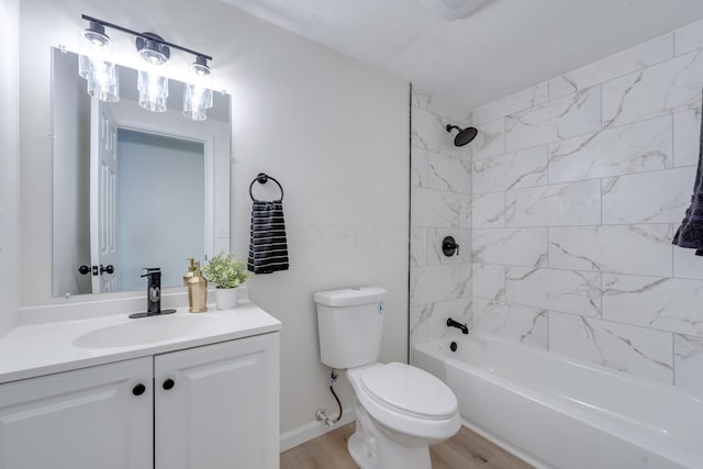 full bathroom with toilet, hardwood / wood-style floors, vanity, and tiled shower / bath combo