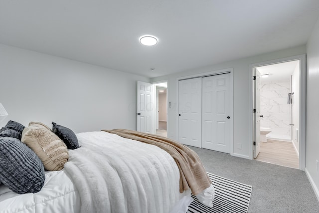 bedroom featuring a closet, connected bathroom, and light colored carpet