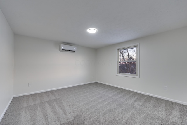 carpeted spare room with an AC wall unit