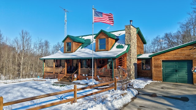 log home with a porch and a garage