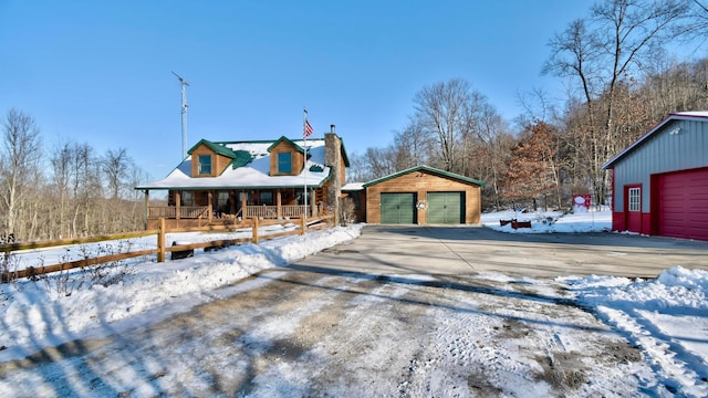 view of front facade with an outbuilding, a porch, and a garage