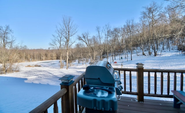 snow covered deck featuring a grill