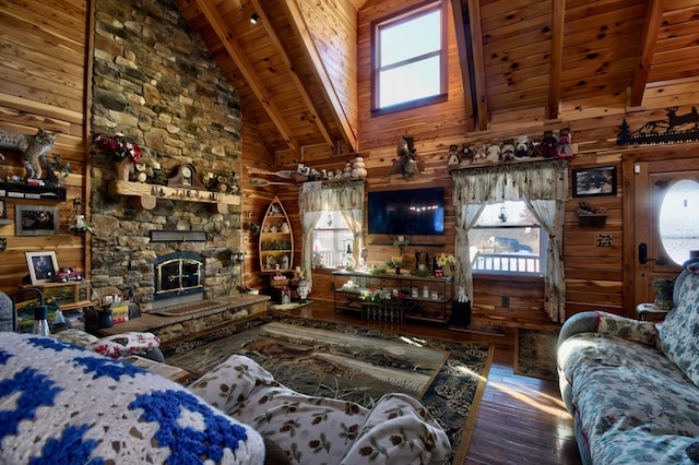 living room with beamed ceiling, wood walls, wood ceiling, and high vaulted ceiling