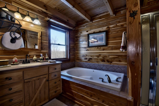 bathroom featuring vanity, wooden ceiling, wooden walls, beam ceiling, and tiled bath