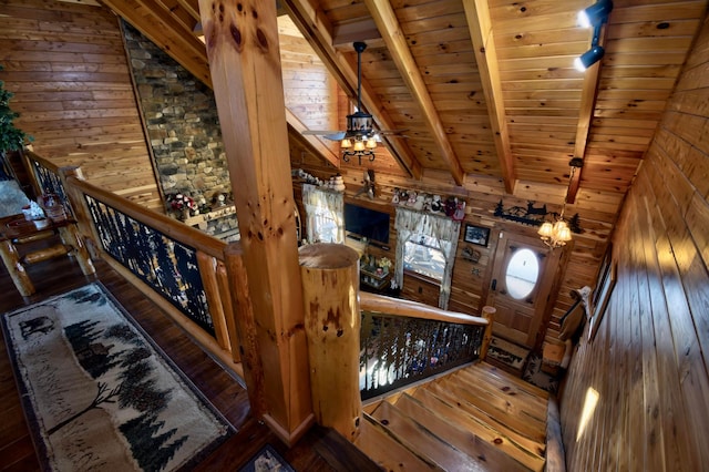 interior space featuring vaulted ceiling with beams, ceiling fan, dark hardwood / wood-style flooring, and wooden ceiling