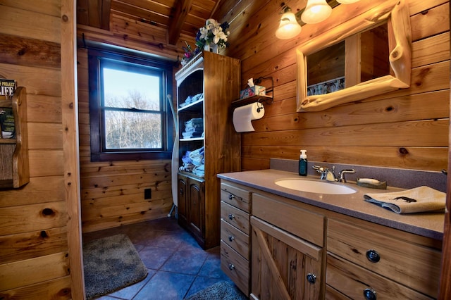 bathroom with wood ceiling, vanity, wooden walls, beam ceiling, and tile patterned flooring