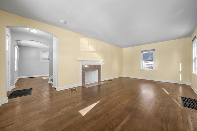 unfurnished living room with dark hardwood / wood-style flooring