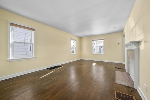 unfurnished living room featuring dark hardwood / wood-style floors