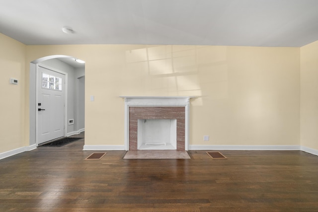 unfurnished living room with dark hardwood / wood-style floors