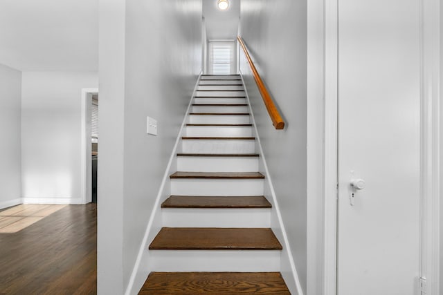 staircase featuring hardwood / wood-style flooring