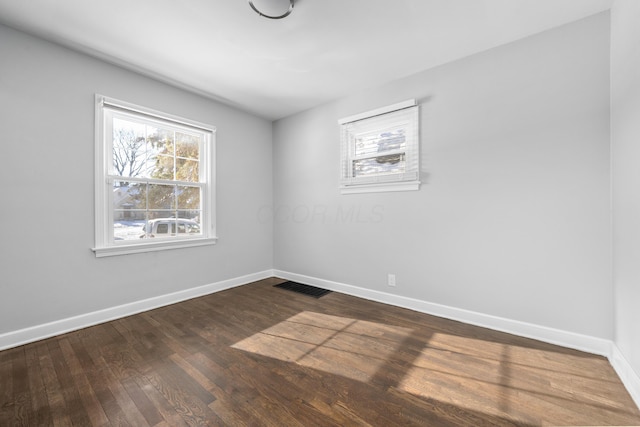 unfurnished room featuring hardwood / wood-style flooring