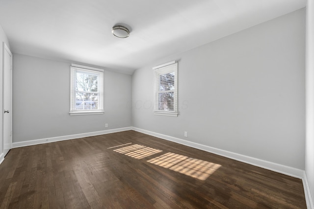 spare room featuring dark hardwood / wood-style flooring