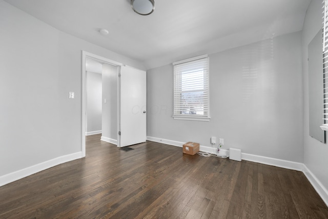 empty room featuring dark hardwood / wood-style flooring