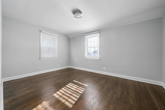 spare room with dark hardwood / wood-style flooring