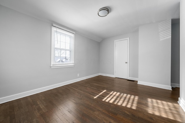 additional living space with dark hardwood / wood-style floors