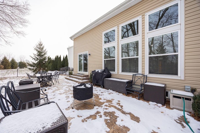 snow covered patio featuring grilling area