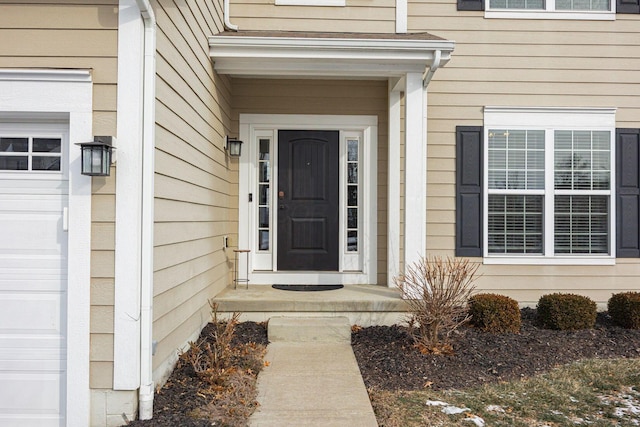 view of exterior entry with a garage