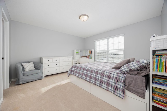 bedroom featuring light carpet