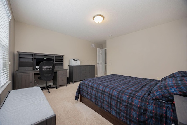 bedroom featuring light colored carpet