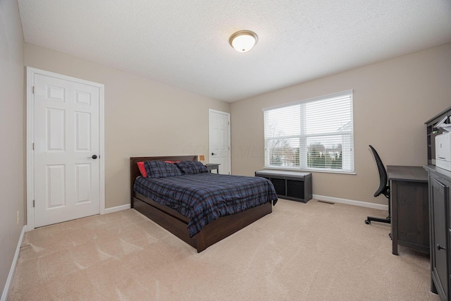 carpeted bedroom with a textured ceiling