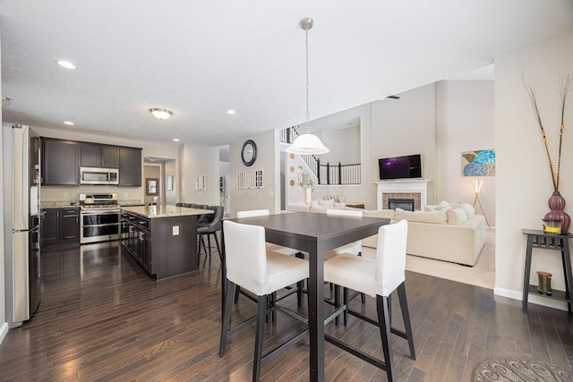 dining area featuring dark hardwood / wood-style flooring and a textured ceiling