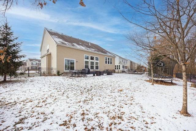 snow covered house with a trampoline