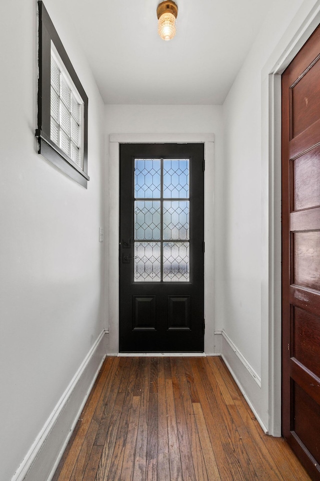 doorway to outside with dark wood-type flooring