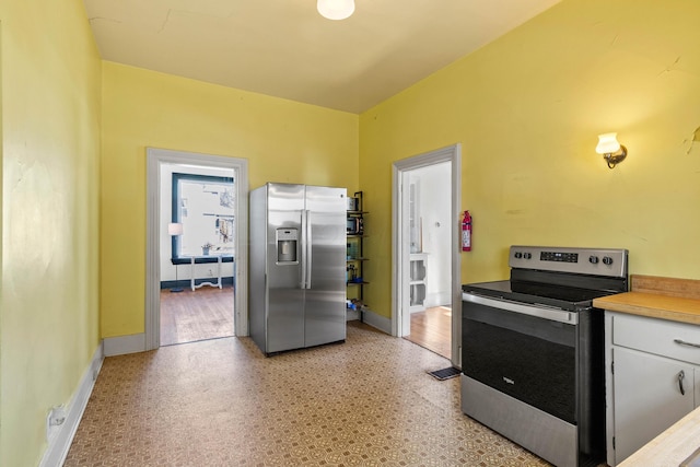 kitchen featuring white cabinets and appliances with stainless steel finishes