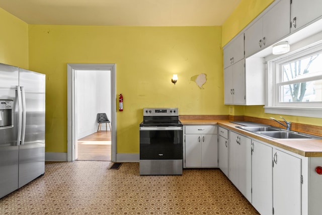 kitchen featuring white cabinets, stainless steel appliances, and sink