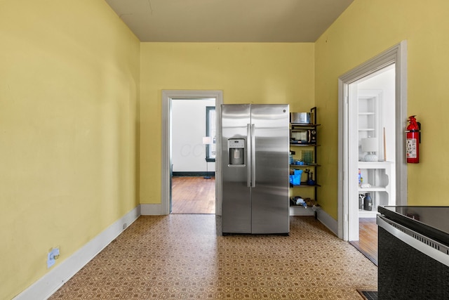 kitchen featuring stainless steel fridge with ice dispenser