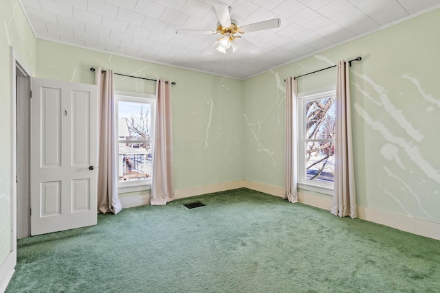 empty room featuring carpet flooring, ceiling fan, and ornamental molding