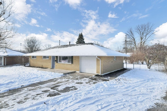 snow covered property featuring a garage