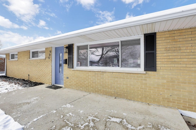 view of exterior entry featuring a patio