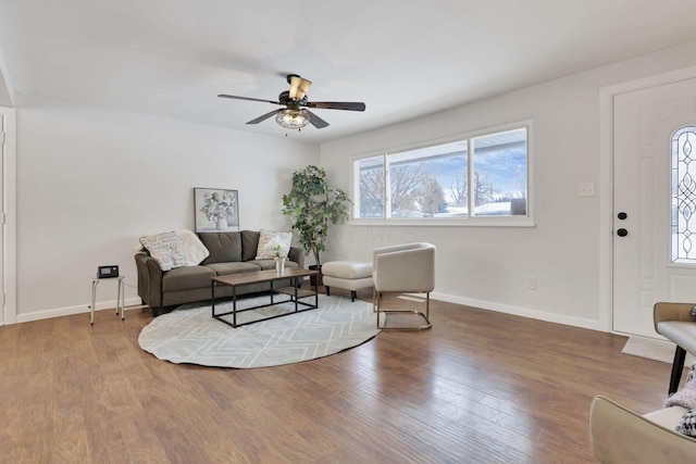 living room featuring ceiling fan and wood-type flooring