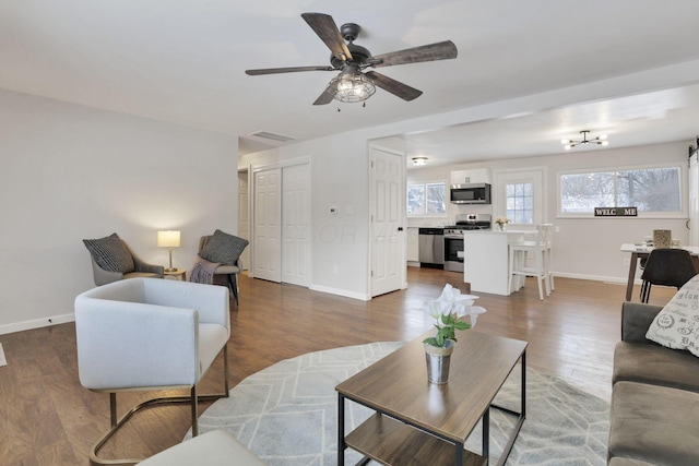 living room with ceiling fan and hardwood / wood-style flooring