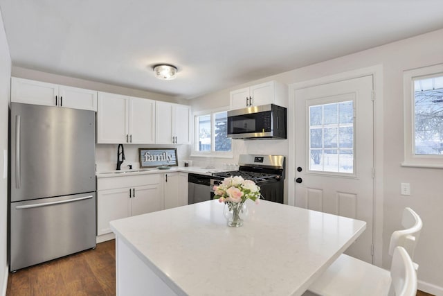 kitchen featuring sink, white cabinetry, and appliances with stainless steel finishes