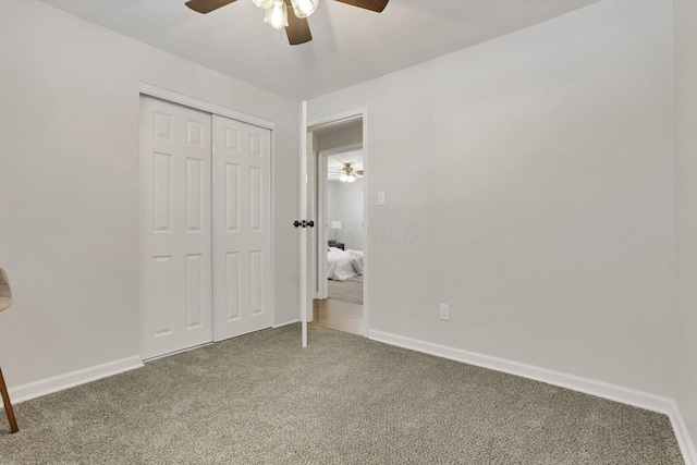 unfurnished bedroom with carpet flooring, ceiling fan, and a closet