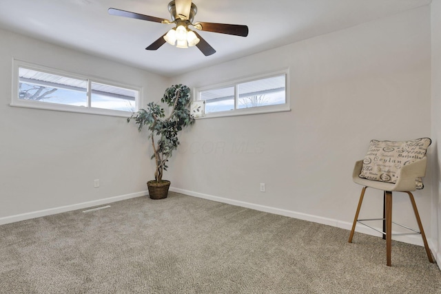 carpeted empty room featuring ceiling fan