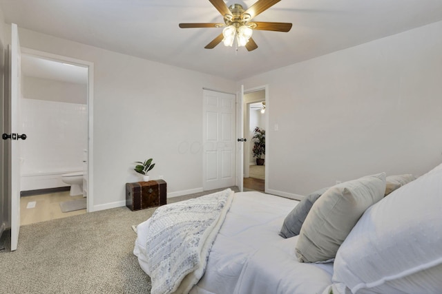 carpeted bedroom featuring ceiling fan and ensuite bathroom