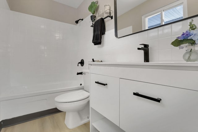 full bathroom with toilet, vanity, hardwood / wood-style flooring, and shower / bathtub combination