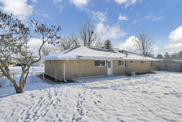 snow covered property featuring central air condition unit