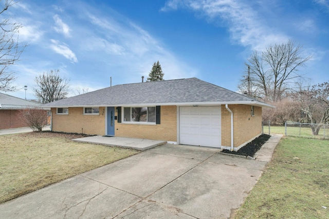 single story home featuring a garage and a front lawn