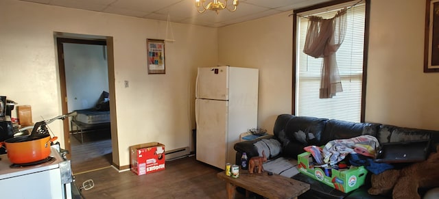 living room featuring dark wood-type flooring, an inviting chandelier, and a baseboard radiator