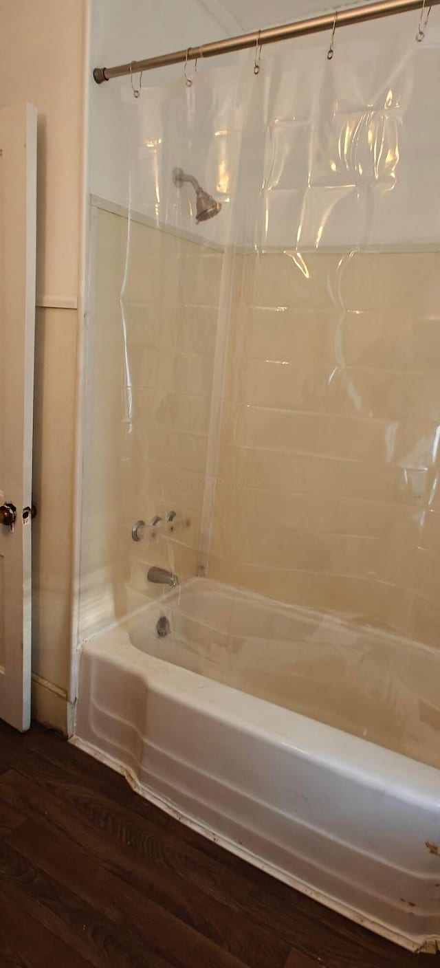 bathroom with shower / tub combo and hardwood / wood-style floors