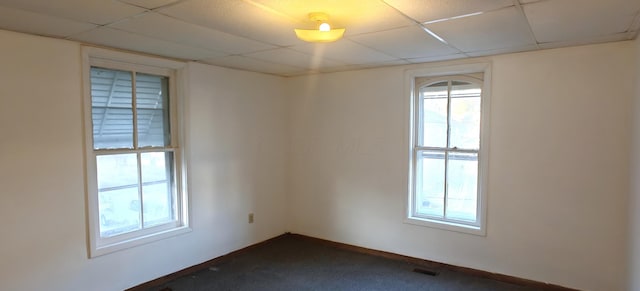 spare room with dark colored carpet