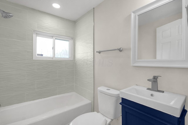 full bathroom with toilet, tiled shower / bath combo, and vanity