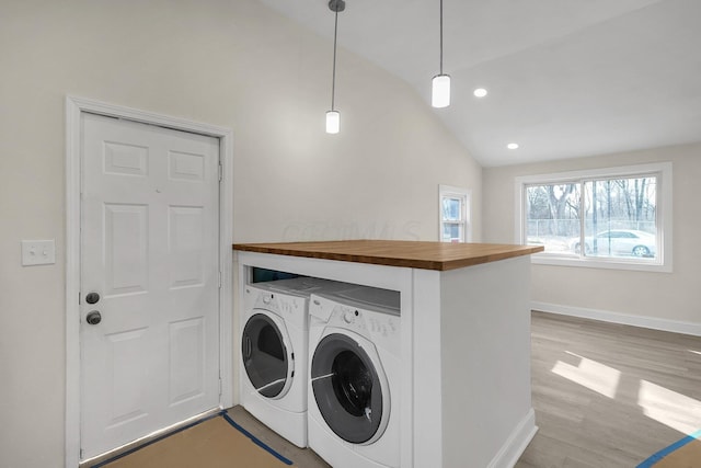 laundry area featuring light wood-type flooring and washing machine and dryer