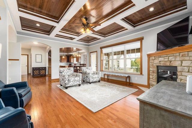 living room with hardwood / wood-style floors, crown molding, and ceiling fan